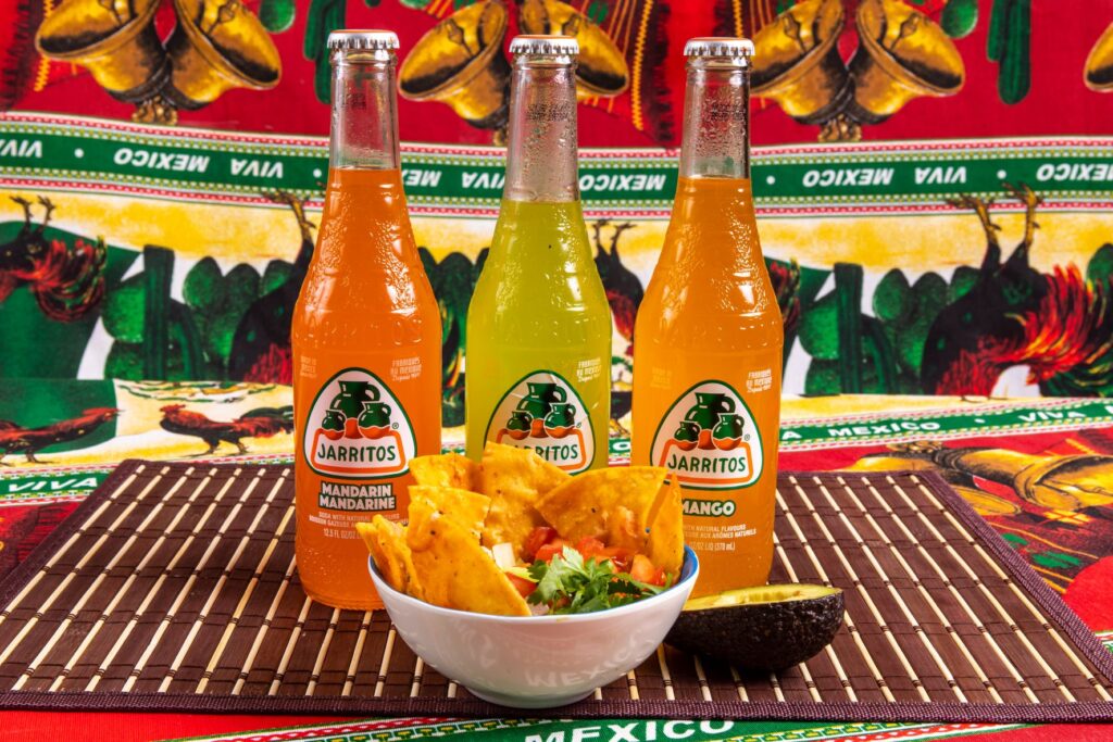 Mexico Drinks Jarritos in front of a bowl of chips and salsa